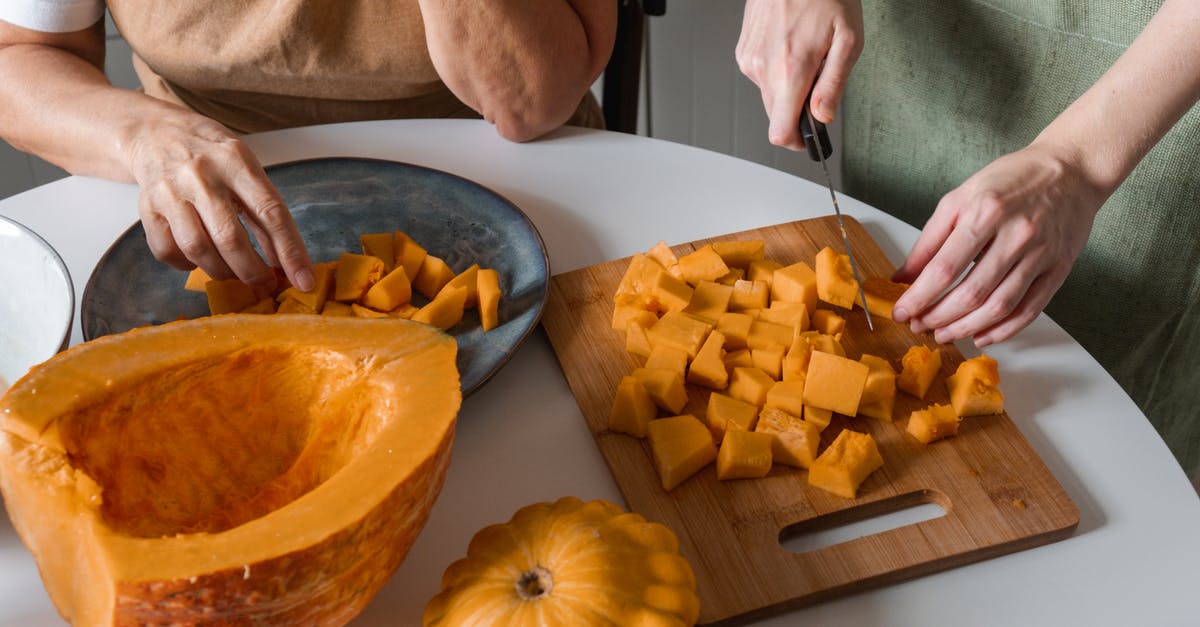 Primer on wooden cutting boards? [duplicate] - Person Slicing a Vegetable on the Wooden Cutting Board