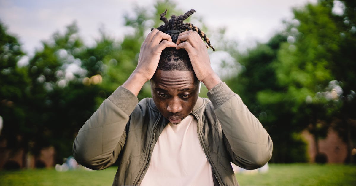 Problems using my black garlic fermenter - Upset young African American male freelancer clutching head with hands after failure in project while working remotely in park