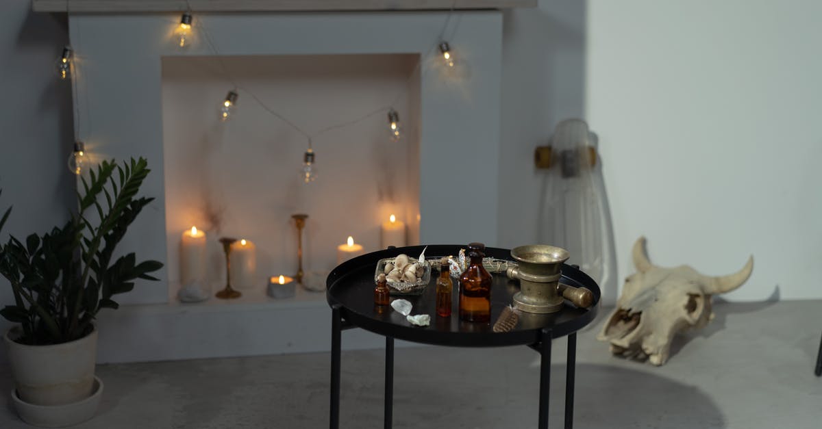 Proper cow bones to prepare holodets - Bottles on Black Round Table in the Room with Fireplace and Cow Skull