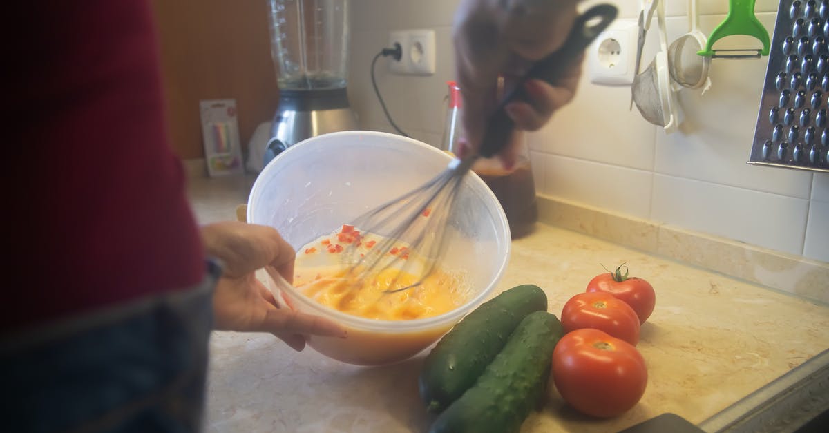 Proper preparation of veggies for an egg scramble - A Person Beating Eggs Using Wire Whisk