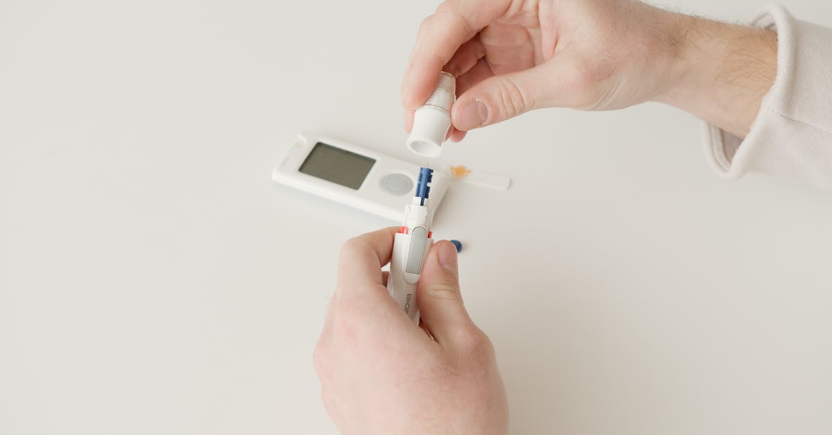 Pudding Control Sample measurements - Person Holding White and Blue Plastic Tube