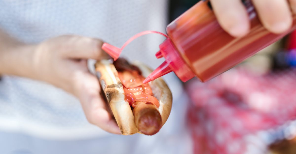 Putting cure in fry sausage? - A Person Putting Ketchup on the Hot Dog