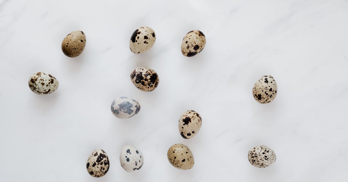 Quail dries out when cooked - Top view of natural quail eggs placed chaotically on white table during cooking process in kitchen