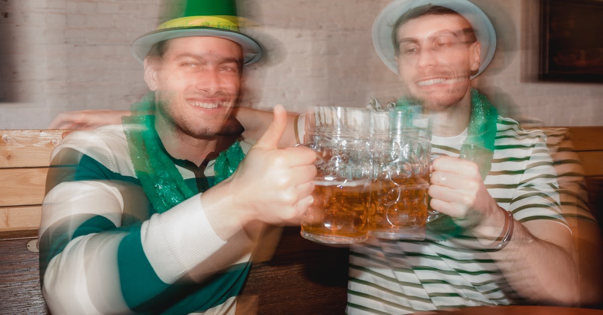 Quiche filling sets like an Aero bar? - Content male partners in shamrock hats with jars of beer celebrating Feast of Saint Patrick at table in pub