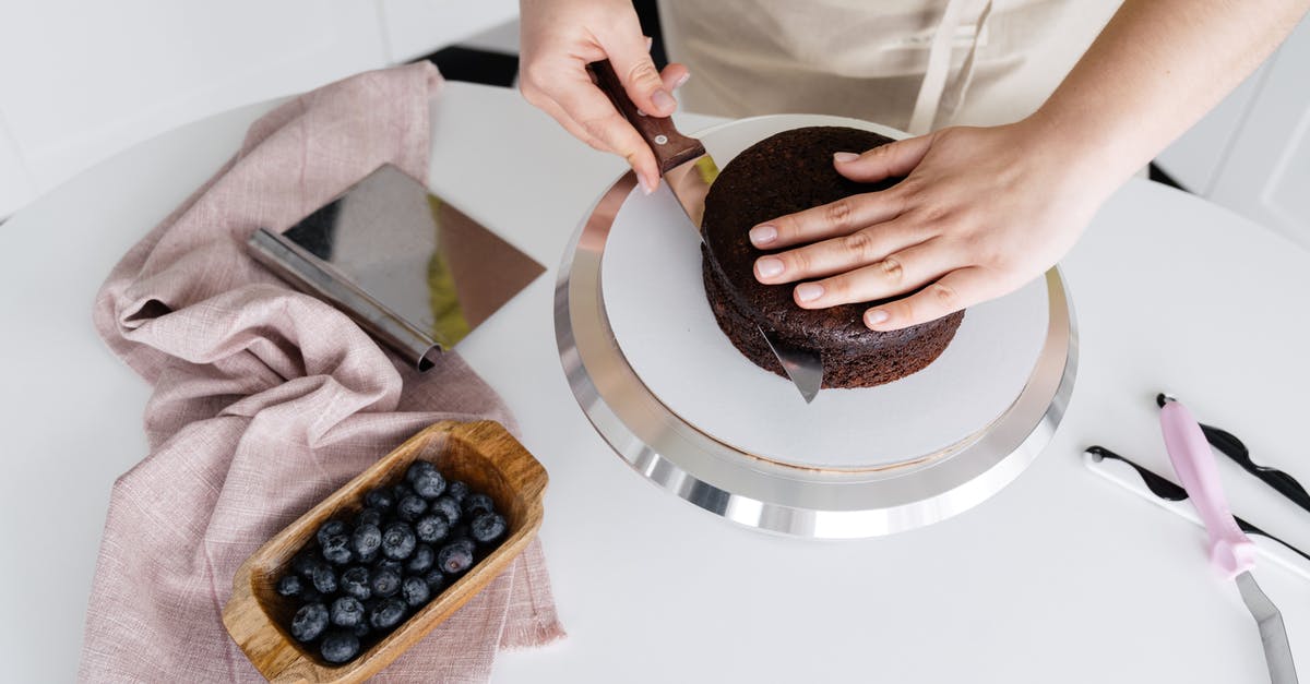 "Cloth" that's edible (or even better, yummy)? - Crop anonymous person cutting delicious homemade cake placed on plate on white table with blueberries and cloth in light kitchen