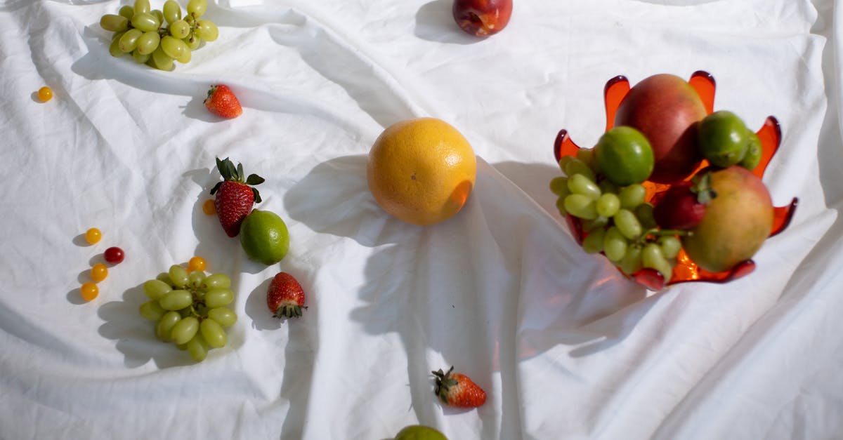 "Cloth" that's edible (or even better, yummy)? - Ripe tasty fruits in glass vase and on white textile