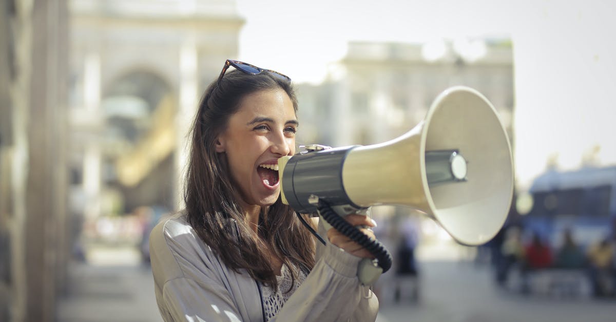 "Screaming" noise while steaming milk? - Cheerful young woman screaming into megaphone