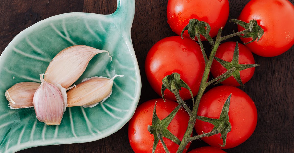 Recipe generator for randomized meal planning [closed] - Tomatoes and plate of cloves on table