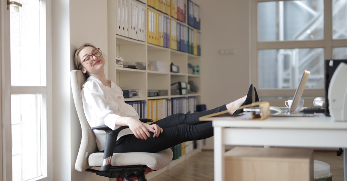 Recipes to calm down my kimchi [closed] - Side view of content female employee wearing formal clothes and eyeglasses sitting on chair with crossed feet on table and chilling during work with closed eyes in modern office