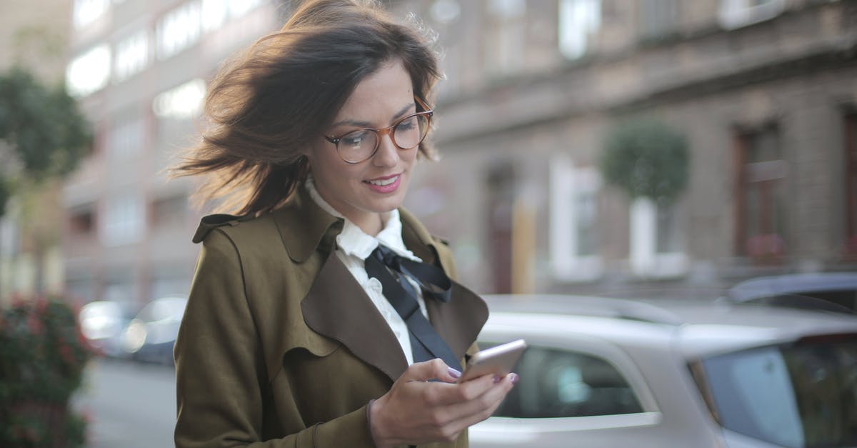 Recomendations in Freezer Use - Stylish adult female using smartphone on street