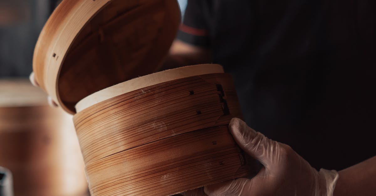 Recommend decent, sturdy steamer basket? - Person Holding Bamboo Round Steamer Basket