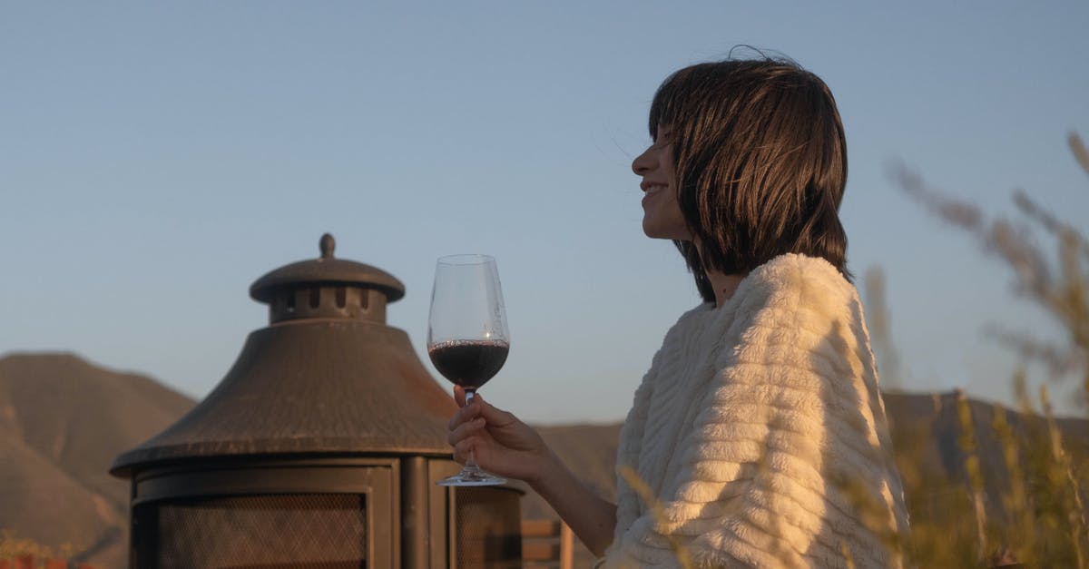 Red v White wine in cooking with a stomach issue - Woman Holding Wine Glass Outdoors