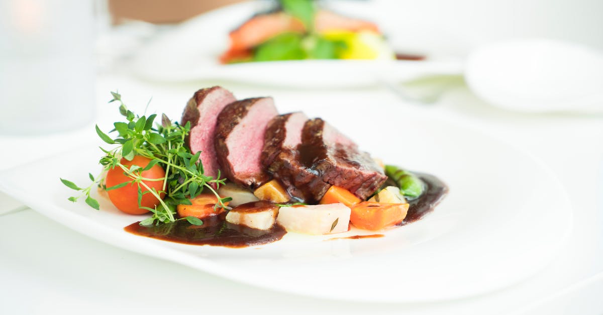 Reducing sauce or gravy always forms a skin - Well-done Beef Steak and Vegetables on Plate