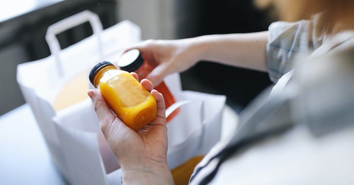 Refreezing bottled juice - Person Holding Orange Plastic Bottle