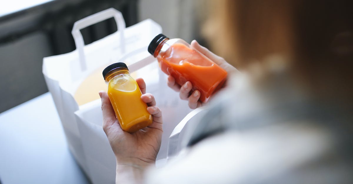 Refreezing bottled juice - Person Holding Orange Plastic Bottle