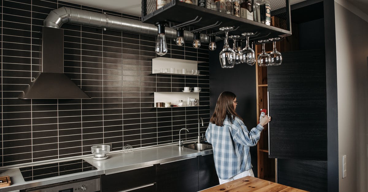 Refrigerate after opening, but why? - Woman in Blue and Gray Long Sleeve Shirt Opening A Refrigerator