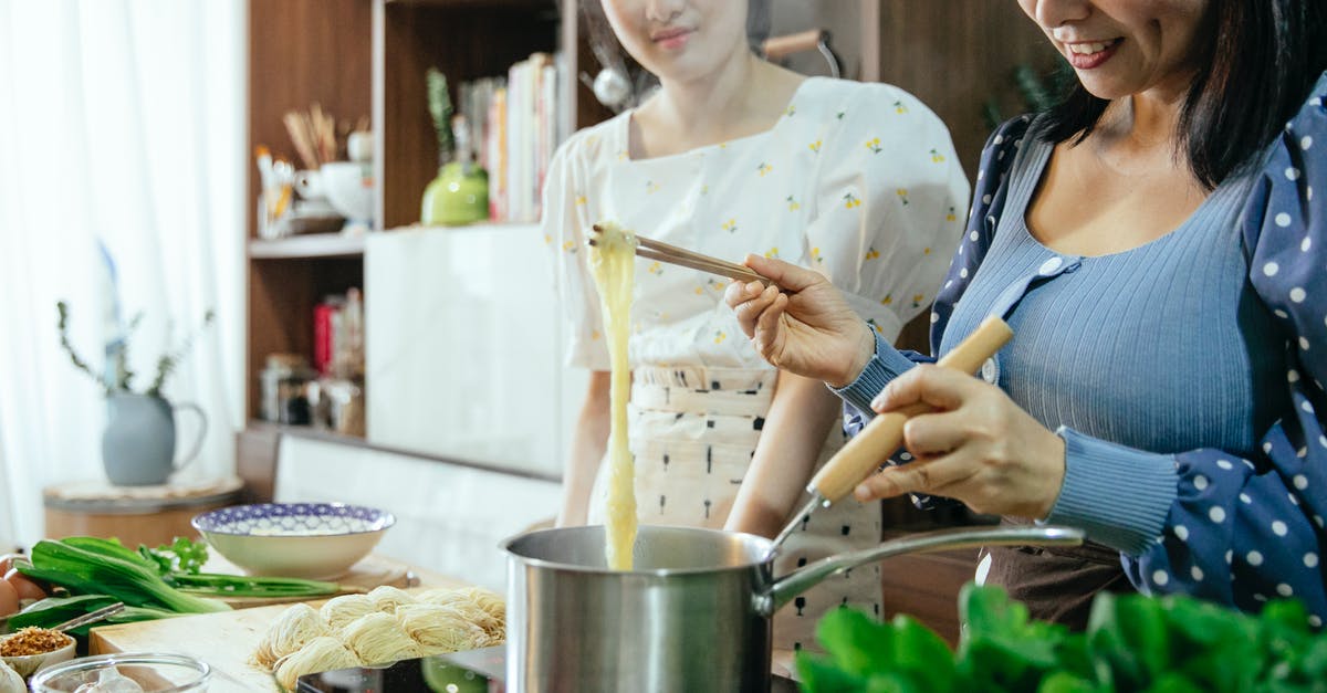 Reheating no boil lentil lasagna noodles after freezing - Woman cooking homemade noodles in kitchen