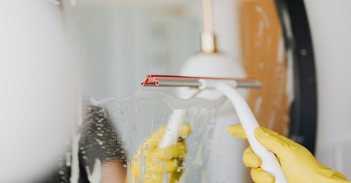 Remove soap water mixed with granulated sugar - Faceless person removing water from mirror