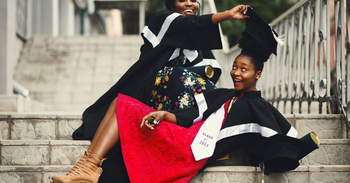 Removing ramekins from a bain marie - Shallow Focus Photography of Two Women in Academic Dress on Flight of Stairs