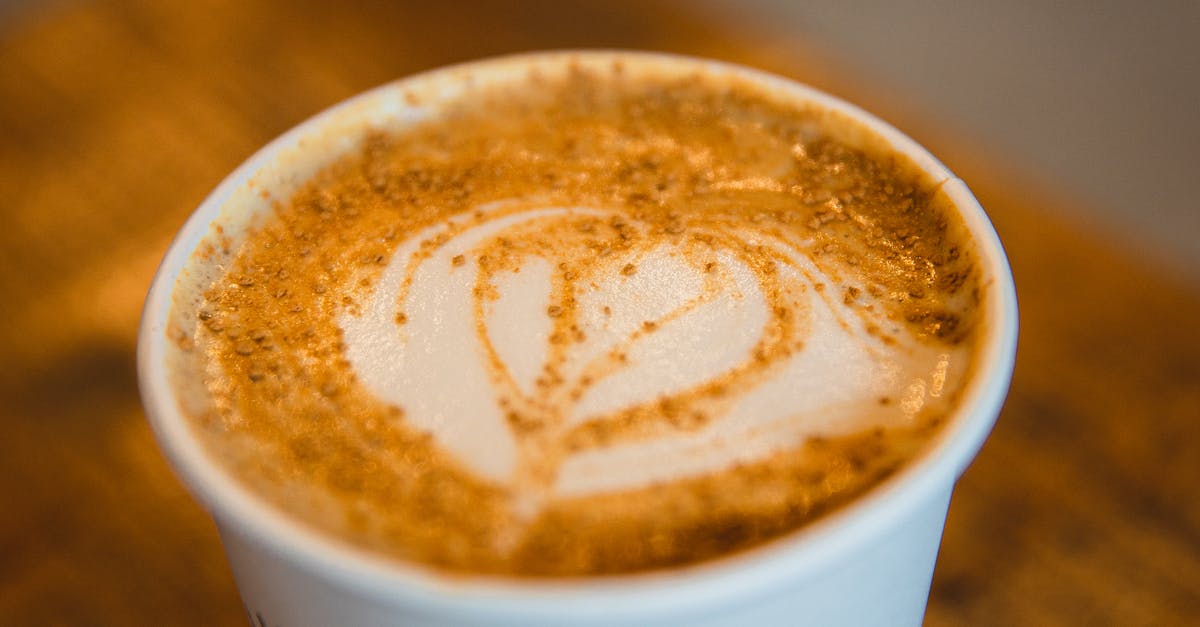 Removing sugar from condensed milk? - From above closeup of cup of hot aromatic cappuccino with art froth at table in coffee shop