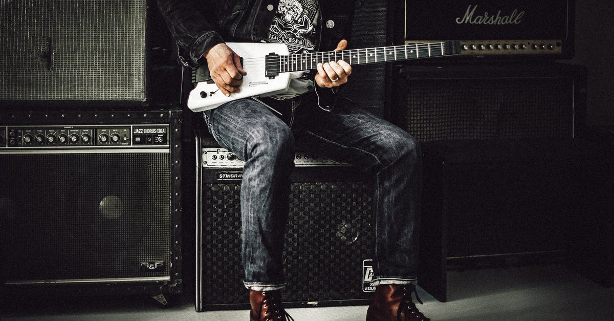 Replacement for pop rocks? - Man Sitting on Guitar Amplifier Playing Electric Guitar