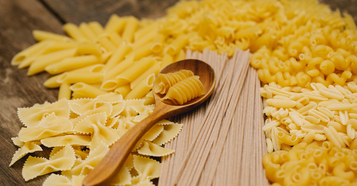 Replicating Good Seasons brand Italian salad dressing dry mix - From above heap of assorted raw pasta of different types scattered on wooden table with spoon in kitchen