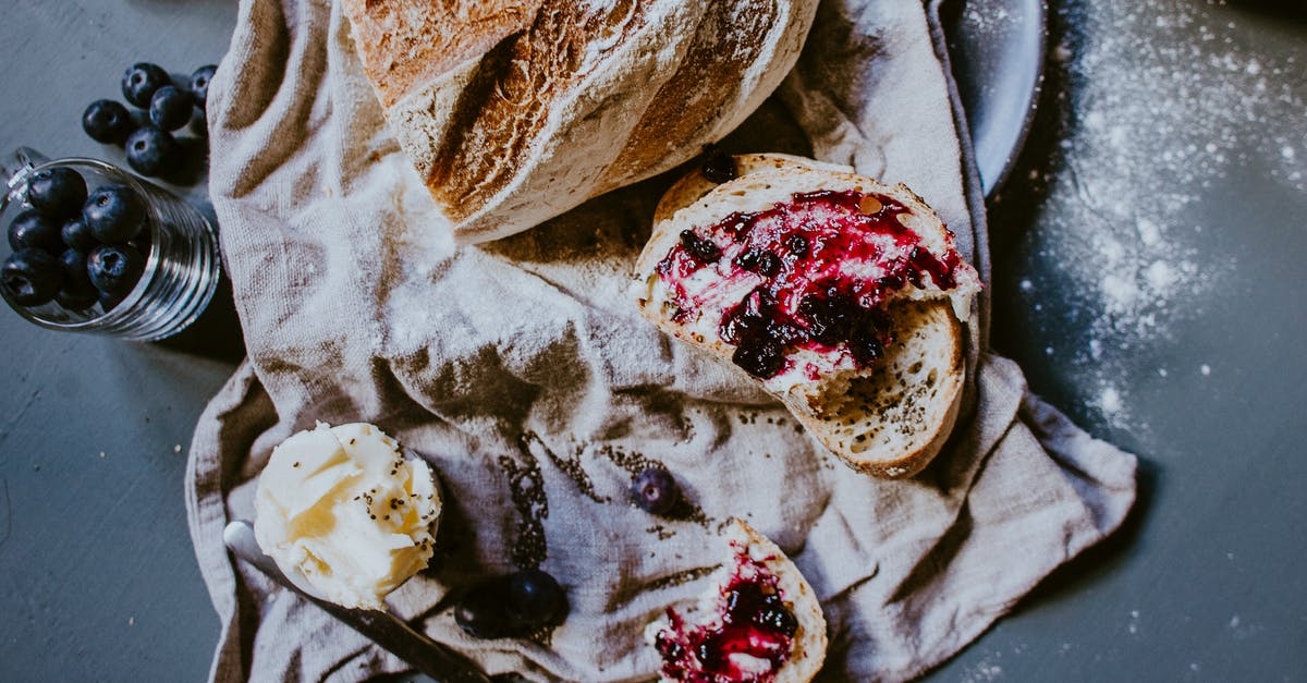 Replicating the thin, soft crust of Portuguese Sweet Bread - Tasty loaf of bread with blueberry confiture on table