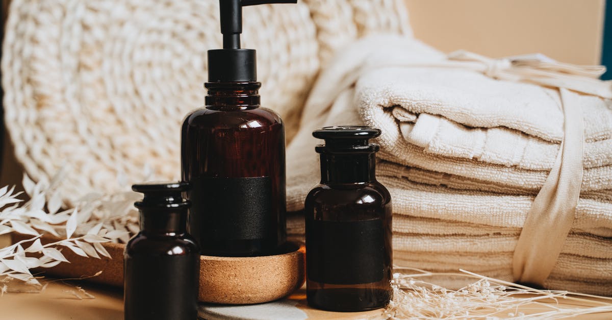 Residue in cork - Brown Bottles and Dried White Flowers Near Folded Towels