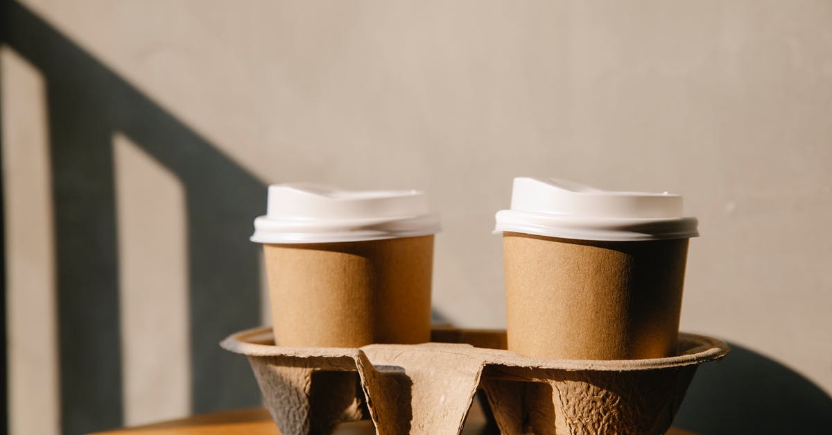 Reusing coffee grounds - Cardboard cups on holder tray on table