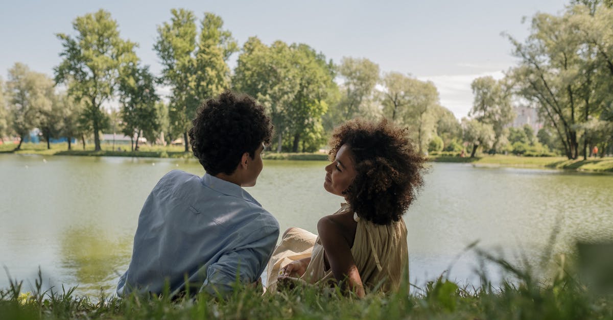 Rice - Expiration Date - Couple Sitting on Grass Field Near Body of Water