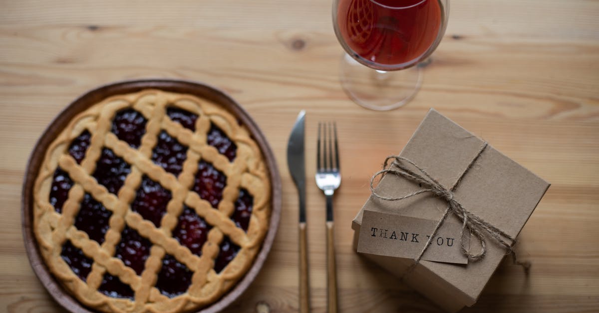 Rice paper cake toppers - Delicious pie near glass of wine and gift box on table