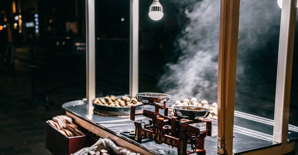 Roast Cooked all night - Roasted chestnuts selling in food cart on street