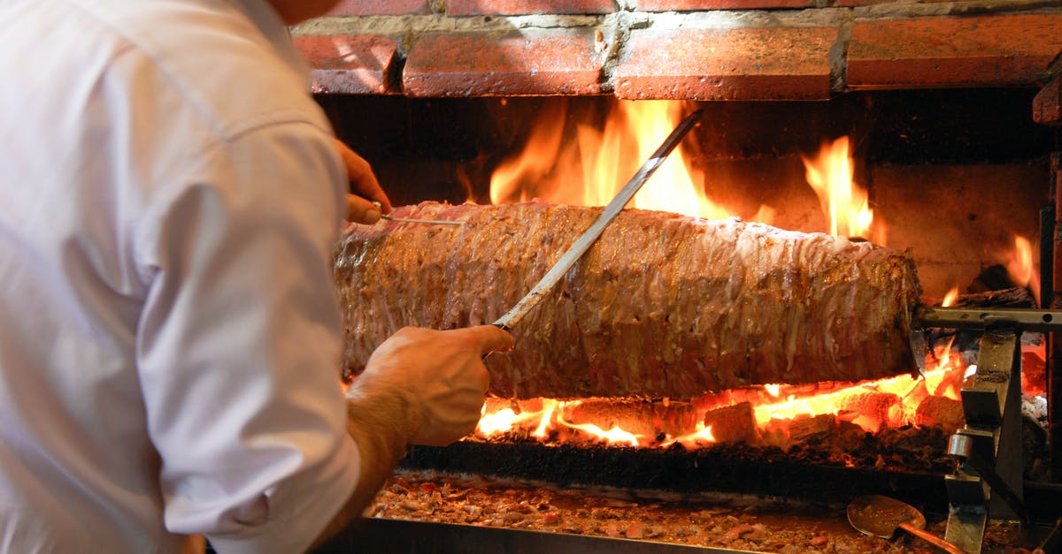 Roasting a turkey in a roaster oven - A Man Roasting on the Brick Oven