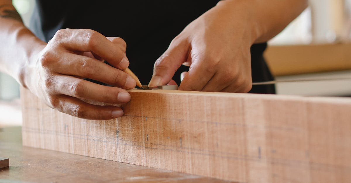 Royal icing - how important is accurate measuring? - Unrecognizable male master using pencil and ruler to measure width of wooden detail while working in professional workshop on blurred background