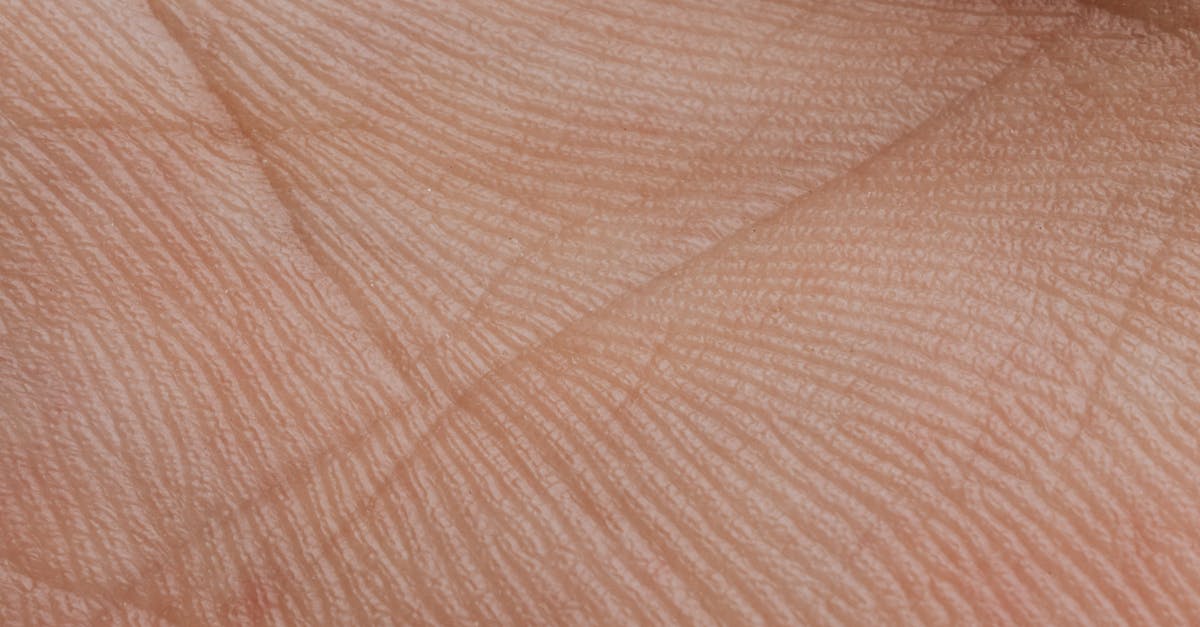 Rubber like skin on surface of chocolate mousse - Close-up View Of Human Palm