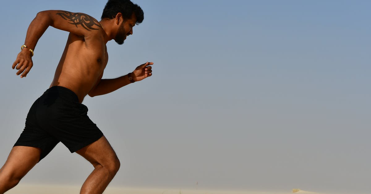 Run gas when outside of home - Strong shirtless sportsman jogging on bright day