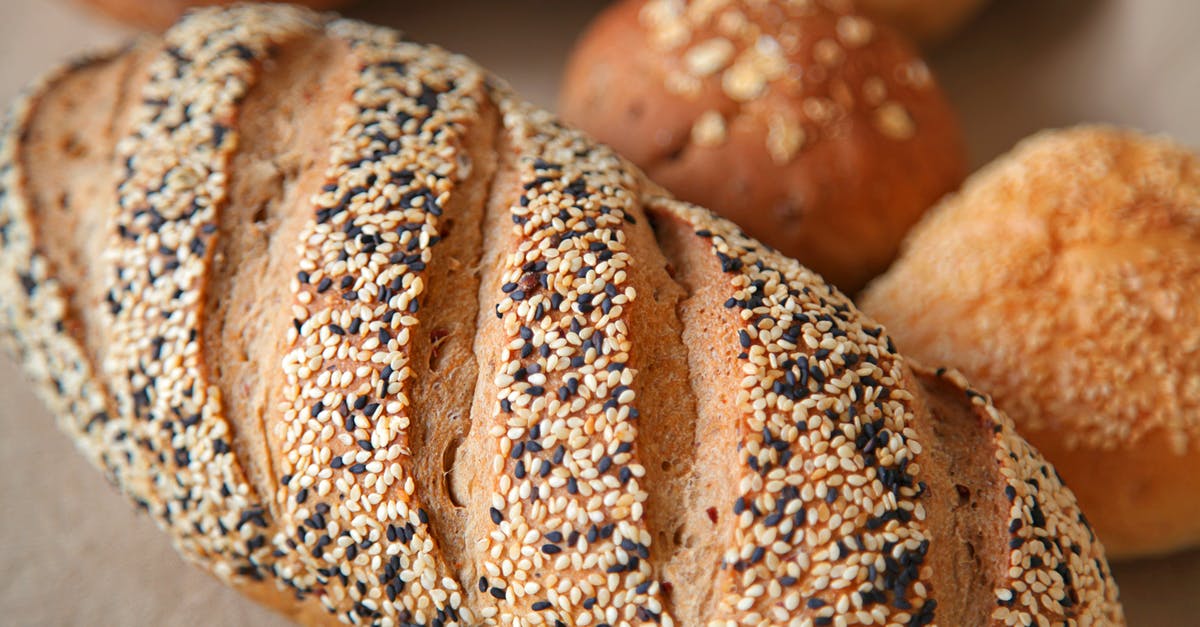 Rye bread: proof until soft - High angle of fresh baked bread with soft buns with sesame seeds served on surface in light place