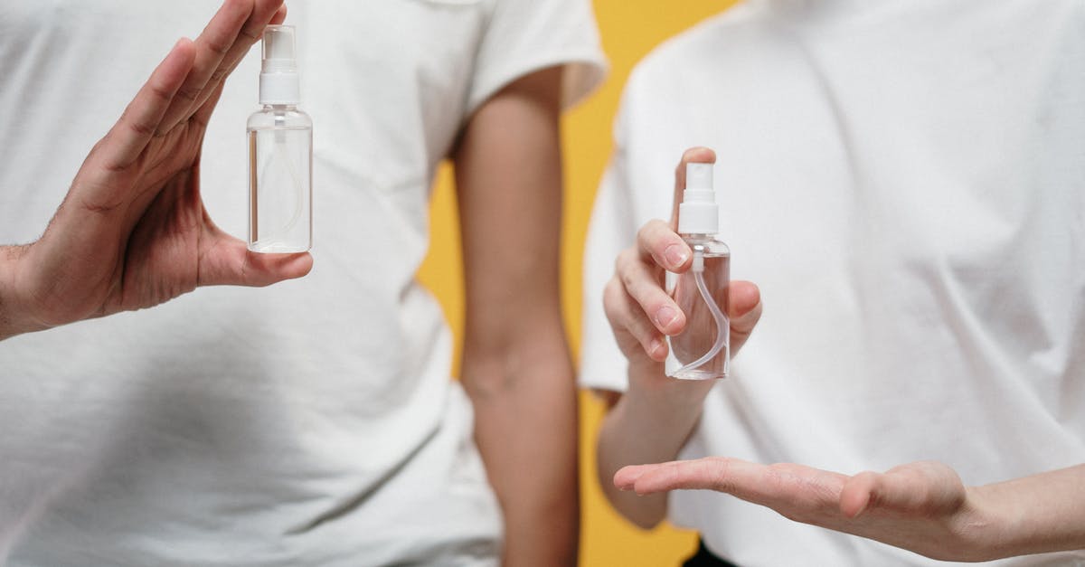 Safe bottles for fermented liquids - People in White Crew Neck T-shirt Holding Clear Spray Bottles