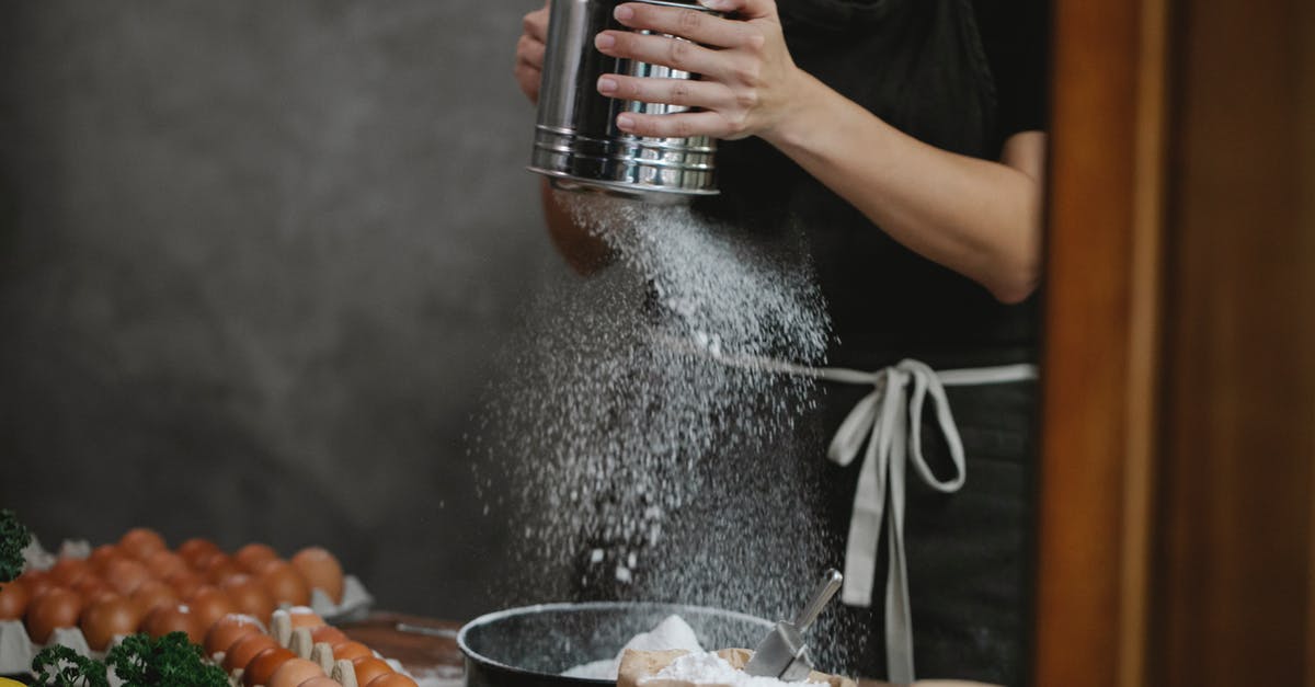 Sanitising Black chef "whites" - Anonymous chef cooking pasta on table near ingredients