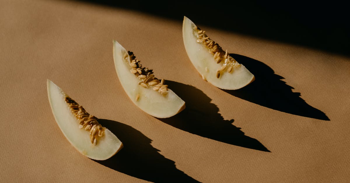 Santa Claus melon seeds - Melon Slices on a Brown Surface 