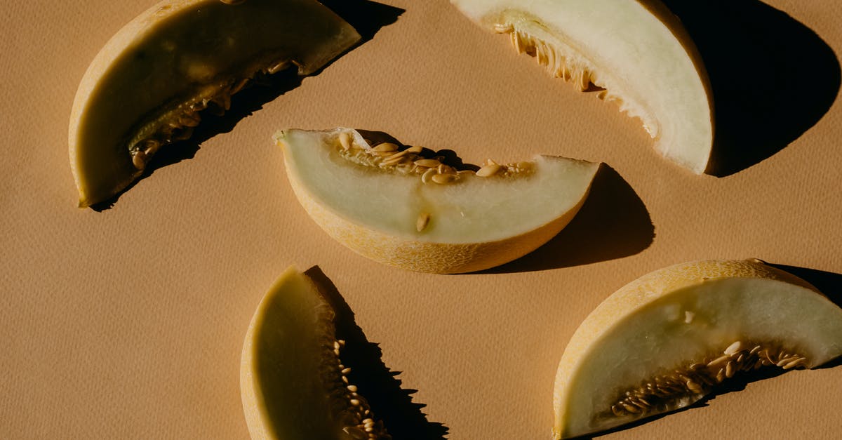 Santa Claus melon seeds - Fruit Slices on a Brown Surface 