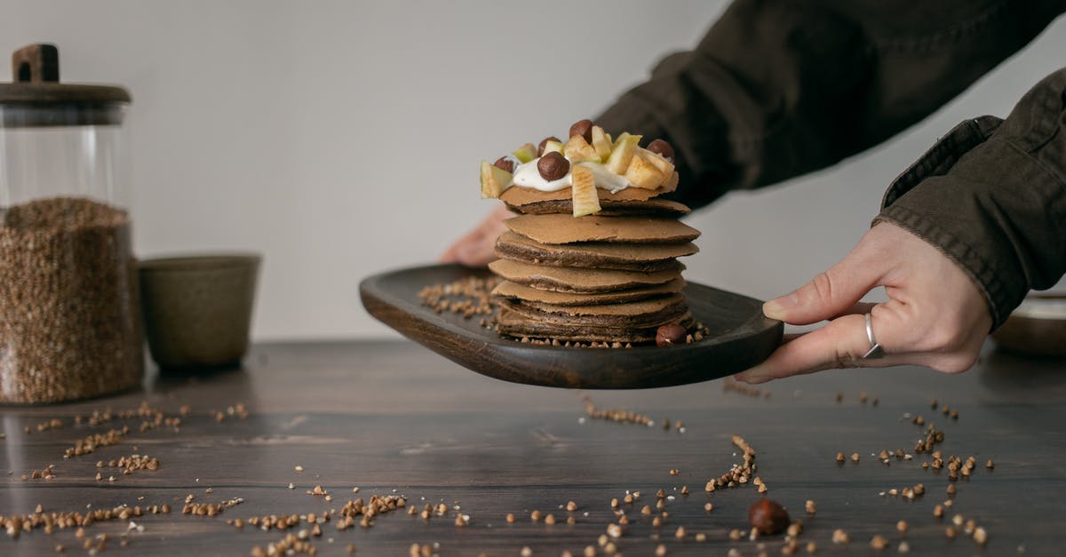 Sauce bubbling out of jar - Unrecognizable woman with tasty pancakes