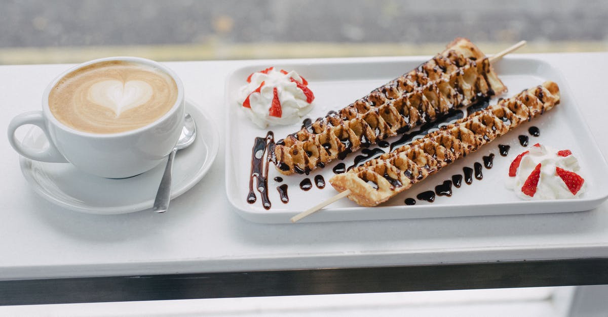 Sauce made from butter and cream flakes/curdles - Tasty waffles covered with chocolate topping and cup of coffee