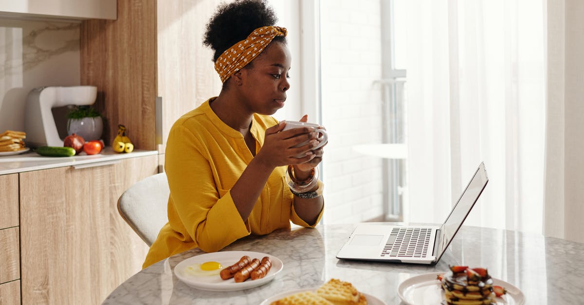 Sausage exploded and looks foamy - A Woman Holding a Cup While Looking at a Laptop