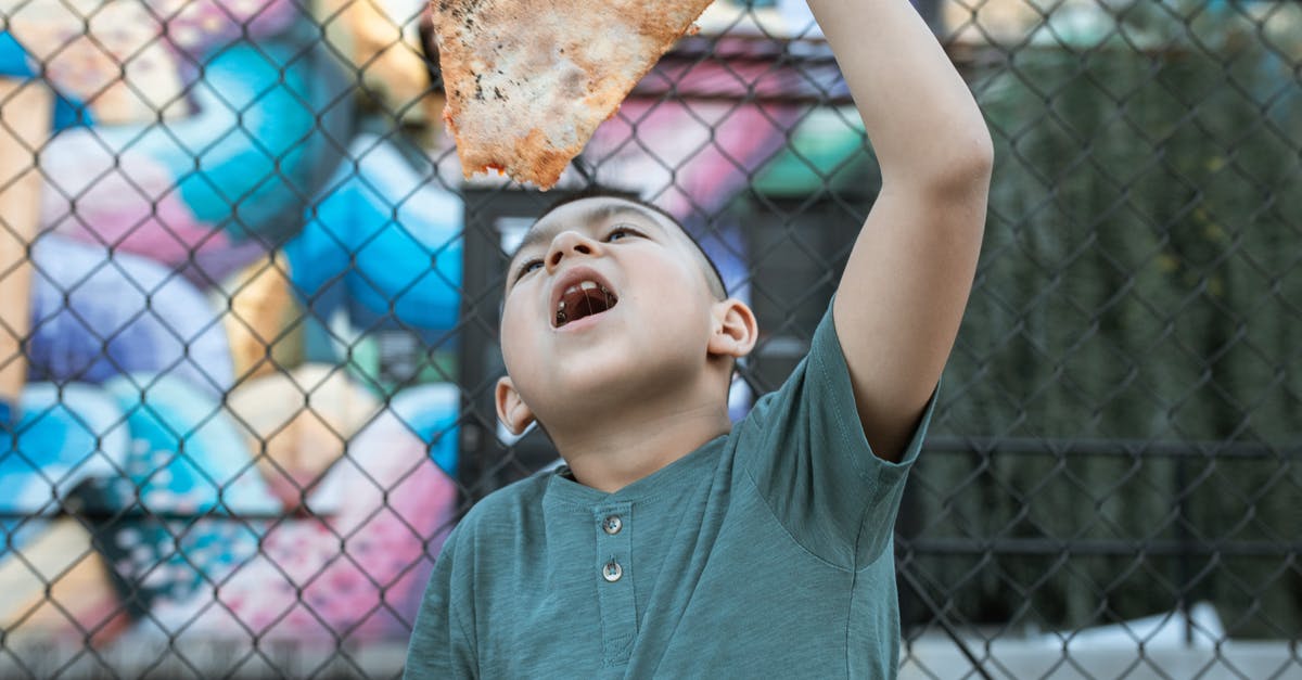 Saving a pavlova that didn't form a crust - Boy in Green Shirt Eating Pizza 