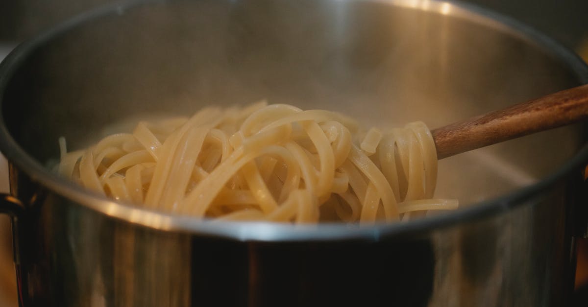 Saving pasta water - Metal pan with pasta in boiling water