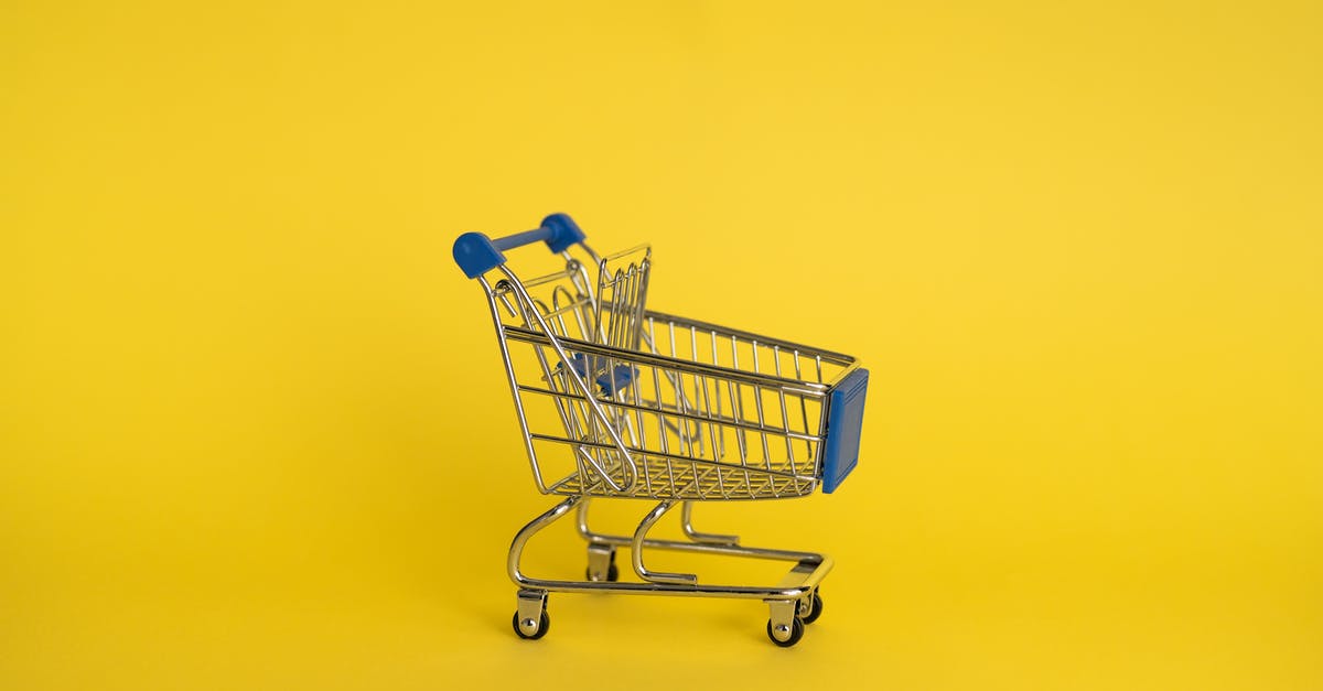Scallops purchased in super market [duplicate] - Isolated shining metal shopping trolley without anything located separately on yellow background