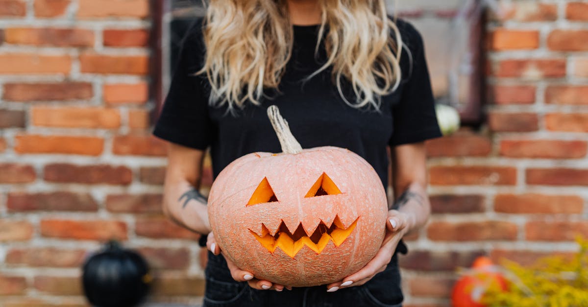 Scary moments - what temperature for broiling? - Woman in Black Crew Neck T-shirt Holding Jack O Lantern