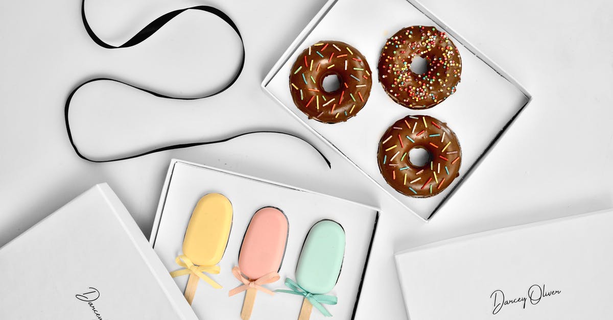 Sealed Bacon Left In an Ice box - Overhead view of collection of colorful doughnut and ice lolly shaped handmade soap in gift boxes near rolled ribbon