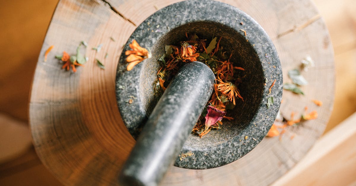 Seasoning a granite mortar and pestle, with intuition for the steps and their order - Black Mortar and Pestle over a Wood